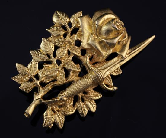 A 1990s gilded Rose & Dagger brooch bearing the signature, Rene Magritte, 2.75in.